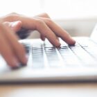 close up male hands typing laptop keyboard min Radio televizija Rožaje