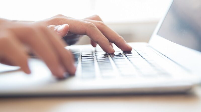 close up male hands typing laptop keyboard min Radio televizija Rožaje